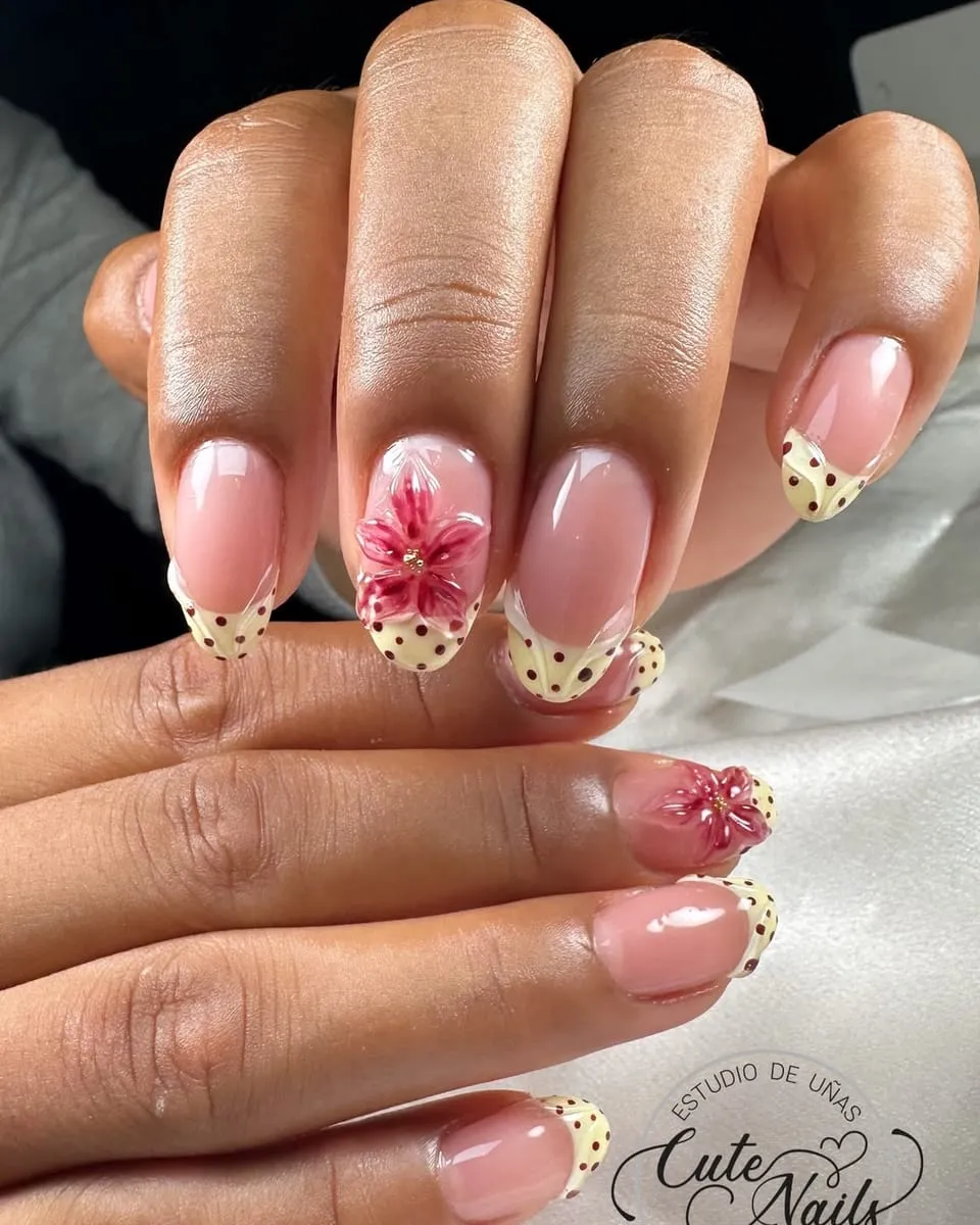 Yellow polka-dot French tips with a painted flower