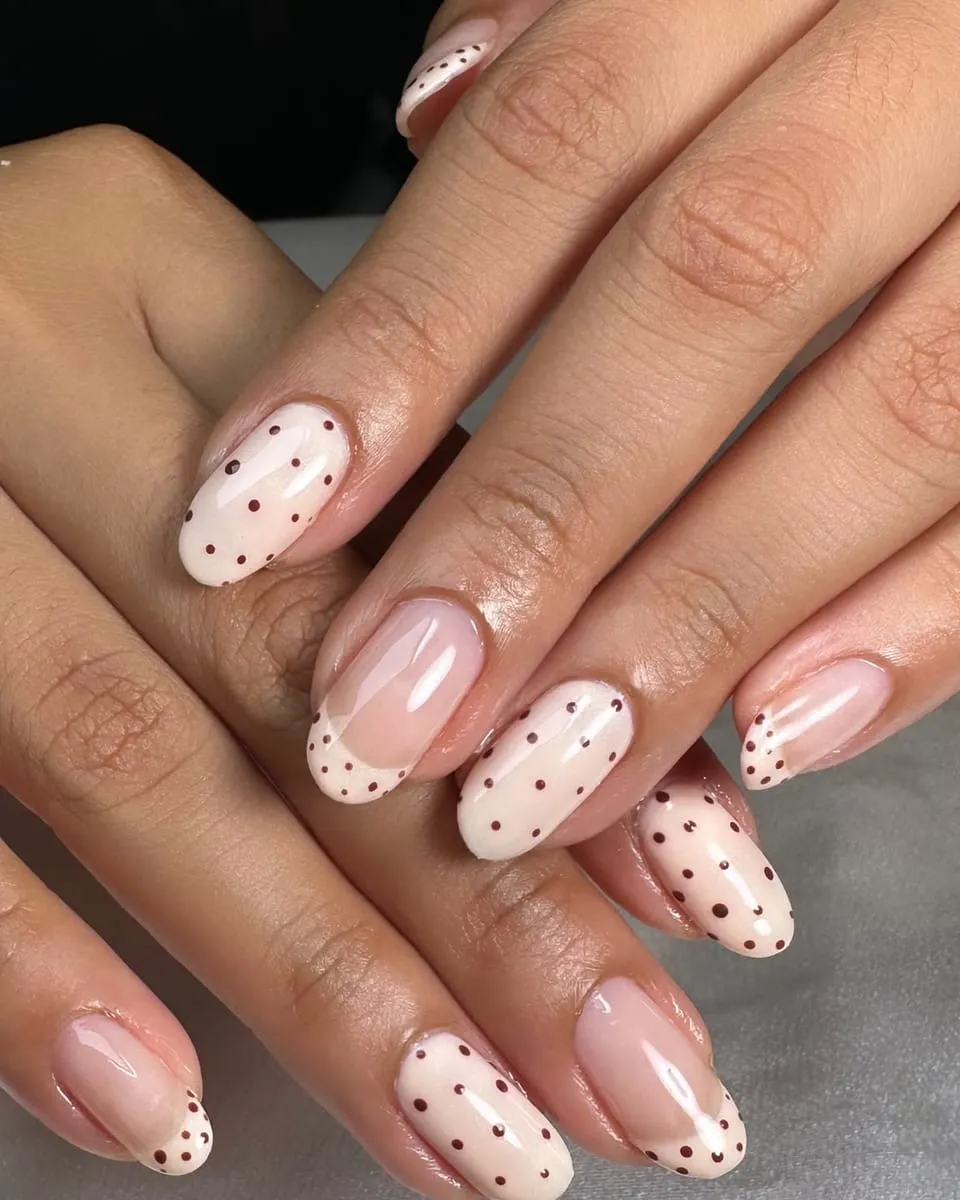 Cream nails with dark polka dots